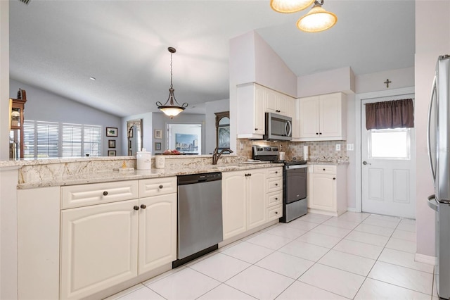 kitchen with a healthy amount of sunlight, stainless steel appliances, and lofted ceiling