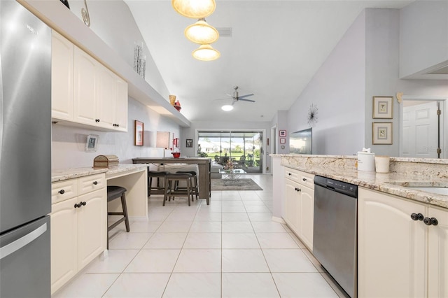 kitchen featuring light stone counters, ceiling fan, light tile patterned floors, high vaulted ceiling, and stainless steel appliances