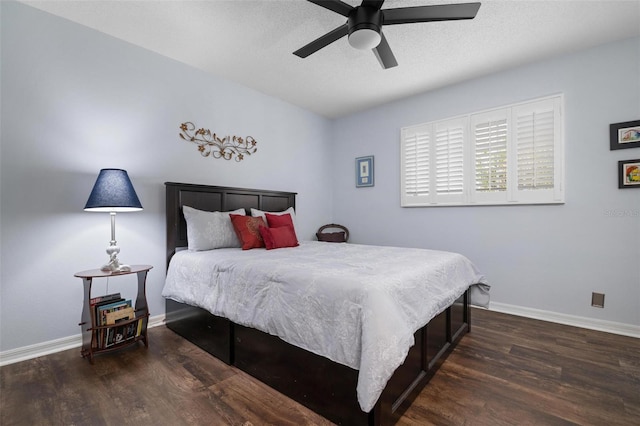 bedroom featuring dark hardwood / wood-style floors, a textured ceiling, and ceiling fan