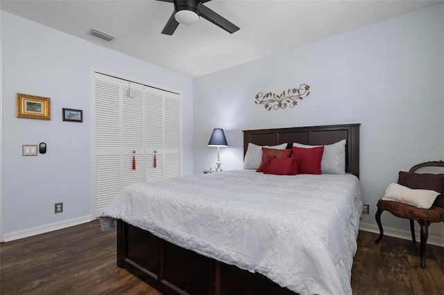 bedroom with dark hardwood / wood-style floors, a closet, and ceiling fan