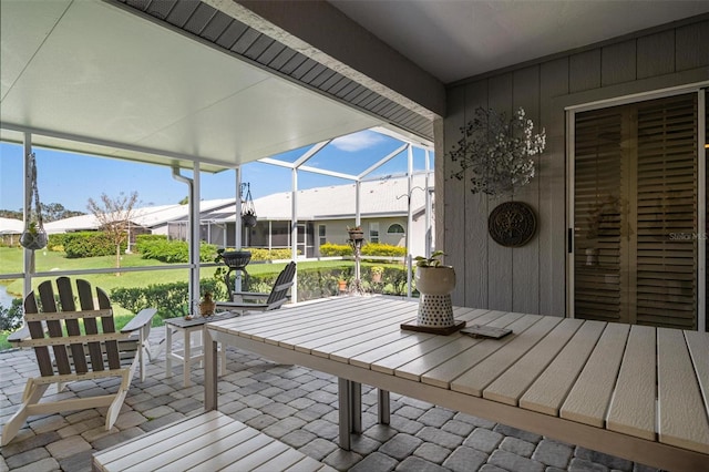 wooden deck with a patio area, a lawn, and a lanai