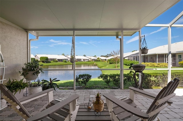 unfurnished sunroom with a water view and a healthy amount of sunlight