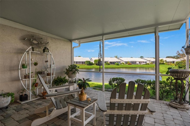 sunroom / solarium with a wealth of natural light and a water view