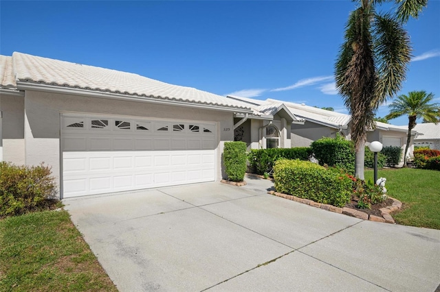 single story home with a front yard and a garage