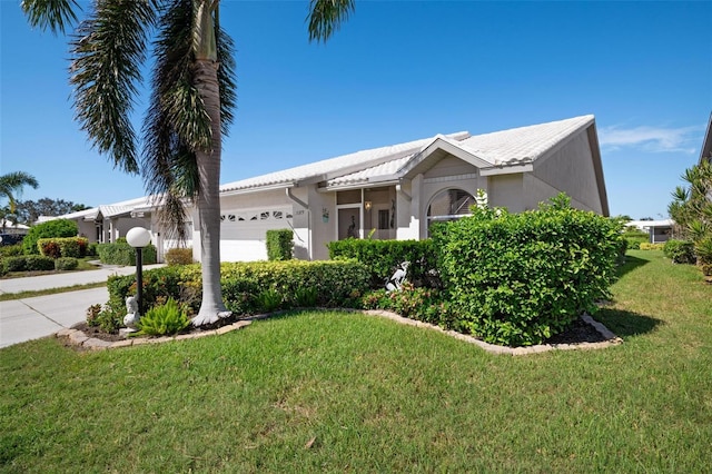 view of front of home featuring a garage and a front lawn