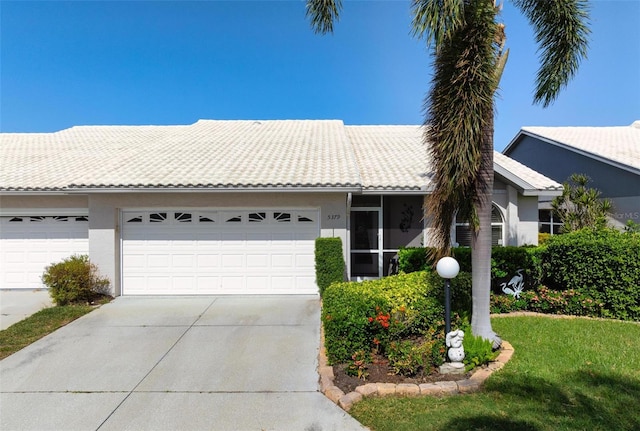 ranch-style home with a front yard and a garage