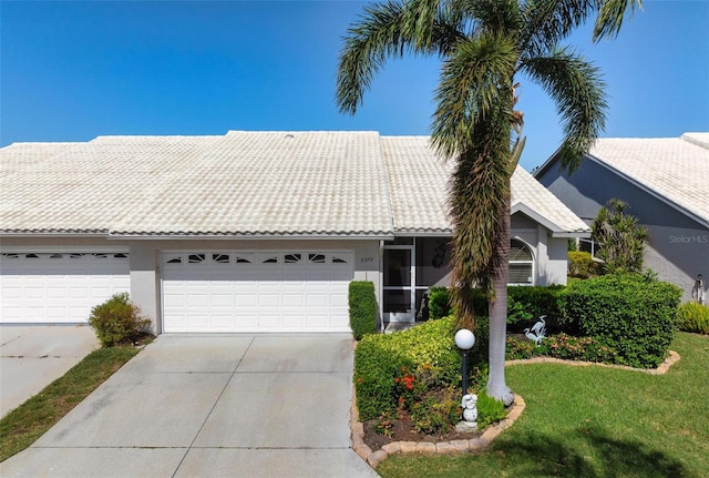 ranch-style house with a garage and a front lawn