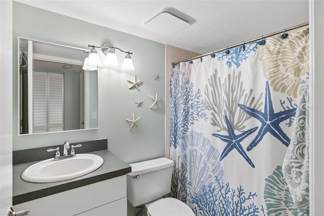 bathroom with vanity, a shower with shower curtain, and toilet