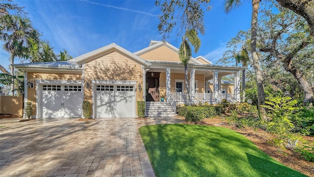 view of front of house featuring a porch and a garage