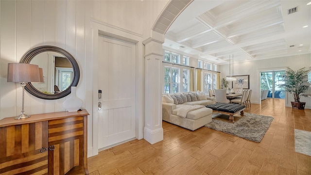 living room with beamed ceiling, light hardwood / wood-style floors, and coffered ceiling