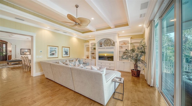 living room with ceiling fan, beam ceiling, crown molding, and light hardwood / wood-style flooring