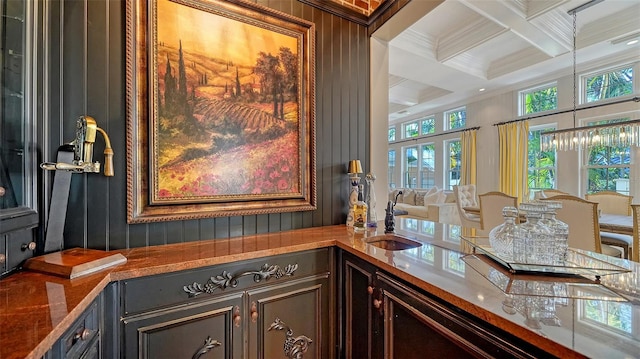 office with beam ceiling, indoor wet bar, coffered ceiling, and ornamental molding