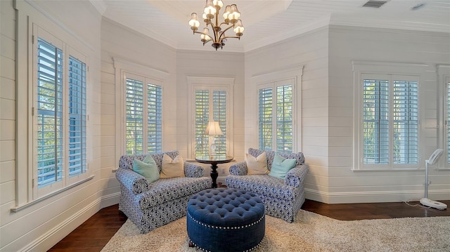 sitting room with a notable chandelier and dark hardwood / wood-style floors