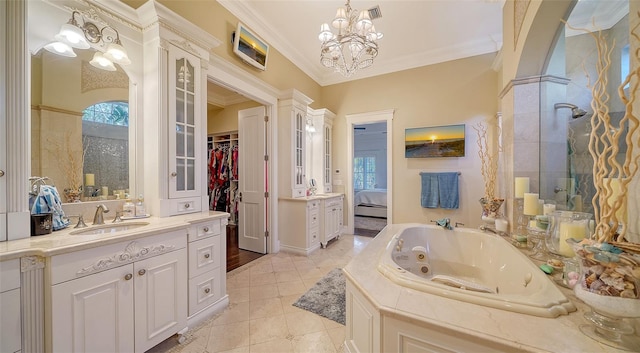 bathroom with vanity, an inviting chandelier, tile patterned floors, ornamental molding, and tiled tub