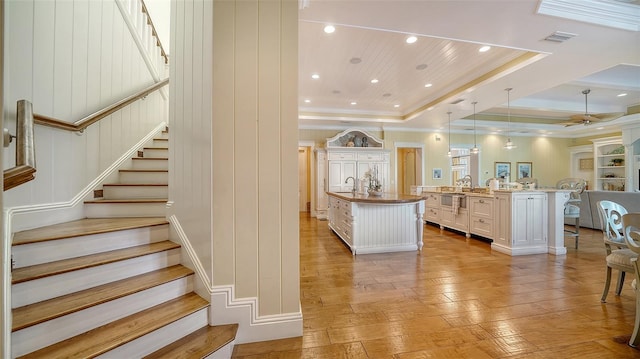 interior space featuring ornamental molding, wood ceiling, a tray ceiling, sink, and hardwood / wood-style flooring