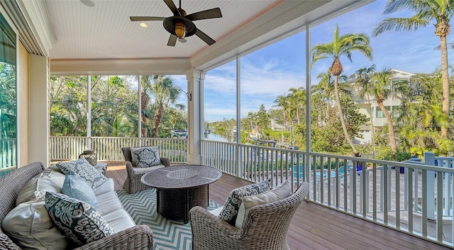 sunroom / solarium featuring ceiling fan