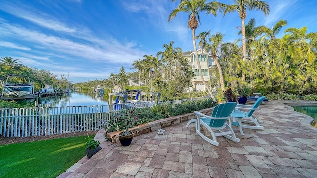 view of patio / terrace with a boat dock and a water view