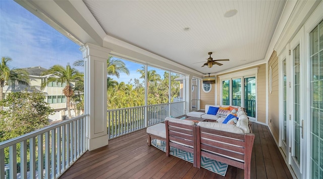 sunroom featuring ceiling fan