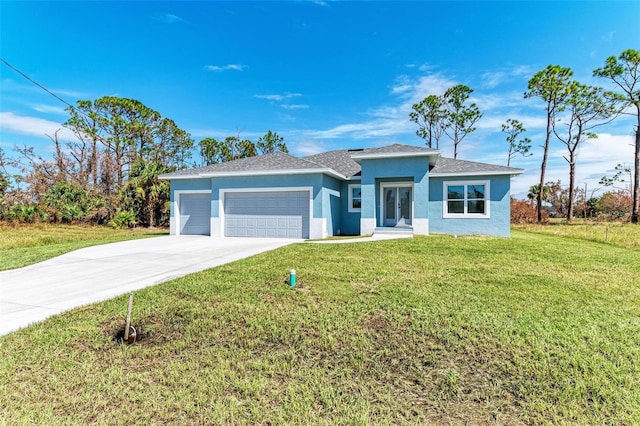 view of front of home featuring a front yard and a garage