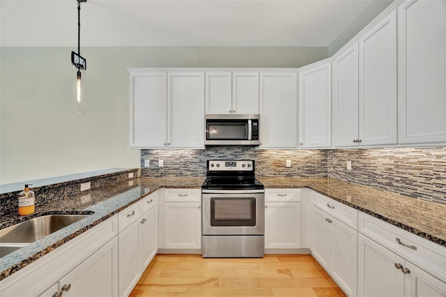 kitchen featuring appliances with stainless steel finishes and white cabinetry