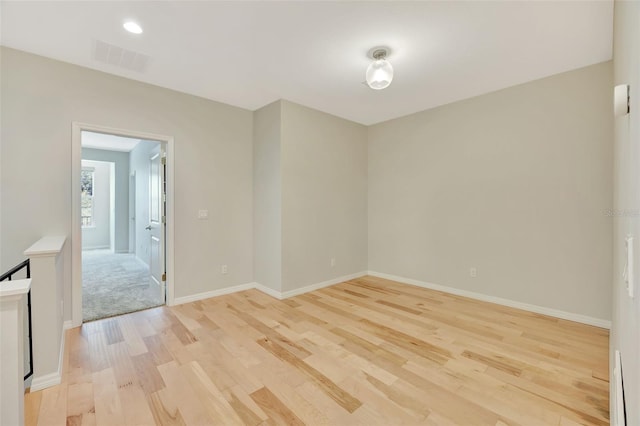 empty room with light hardwood / wood-style flooring