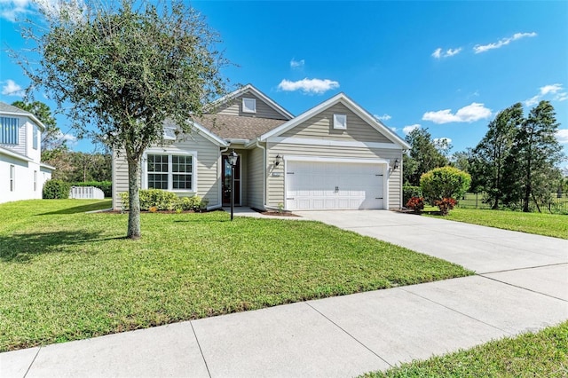 view of front of home with a garage and a front lawn