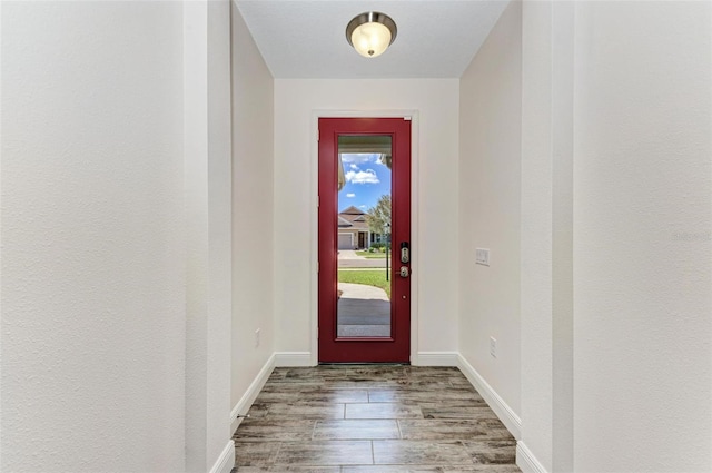 doorway with hardwood / wood-style flooring