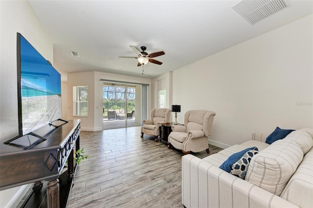 living room with light wood-type flooring and ceiling fan