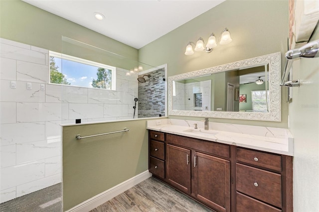 bathroom featuring vanity, ceiling fan, tiled shower, and hardwood / wood-style floors