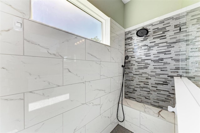 bathroom with tiled shower