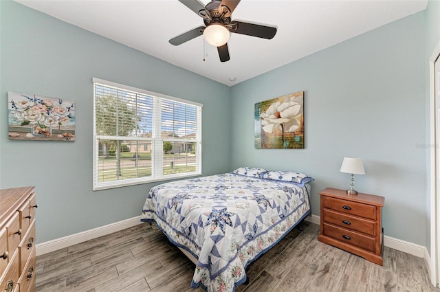 bedroom with hardwood / wood-style flooring and ceiling fan