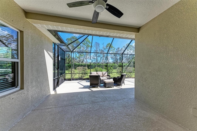 view of patio / terrace with ceiling fan, a lanai, and outdoor lounge area