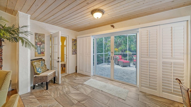 doorway to outside with french doors and wood ceiling