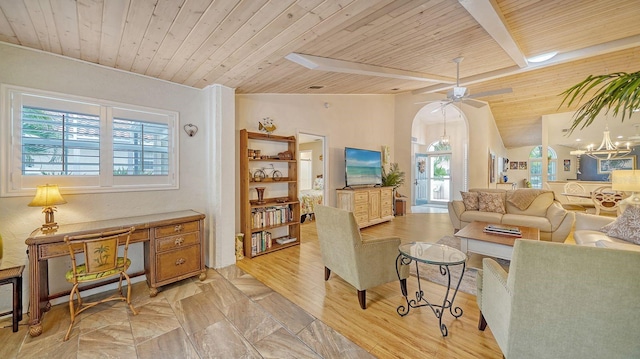 living room with vaulted ceiling with beams, wooden ceiling, ceiling fan with notable chandelier, and light wood-type flooring