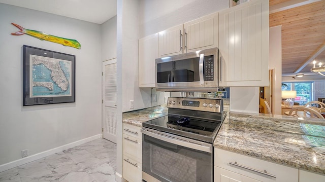 kitchen featuring light stone counters and stainless steel appliances