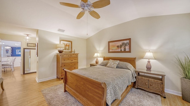 bedroom with light hardwood / wood-style flooring, lofted ceiling, and ceiling fan