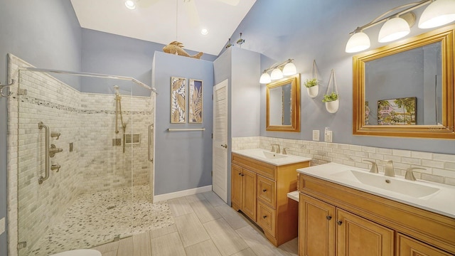 bathroom with a shower with door and vanity