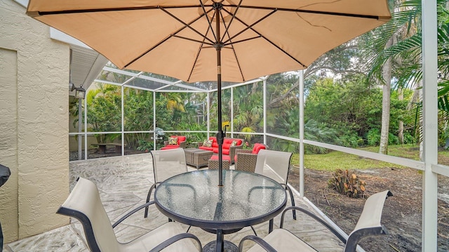 view of patio featuring glass enclosure