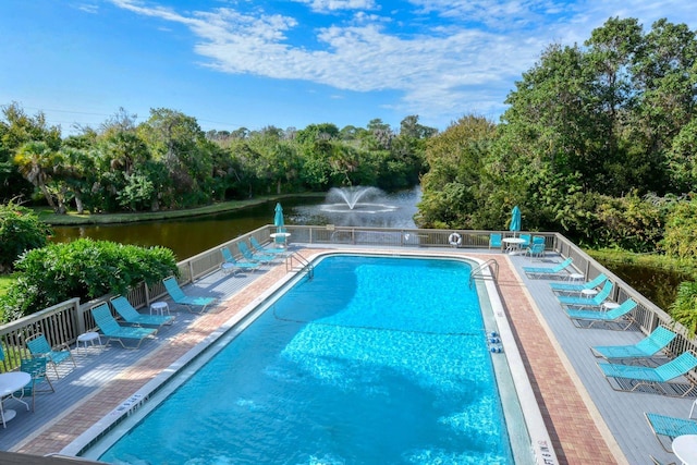 view of swimming pool with a water view