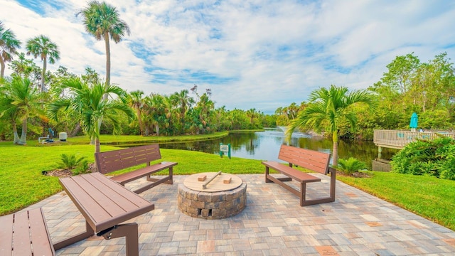 view of patio with a water view and an outdoor fire pit