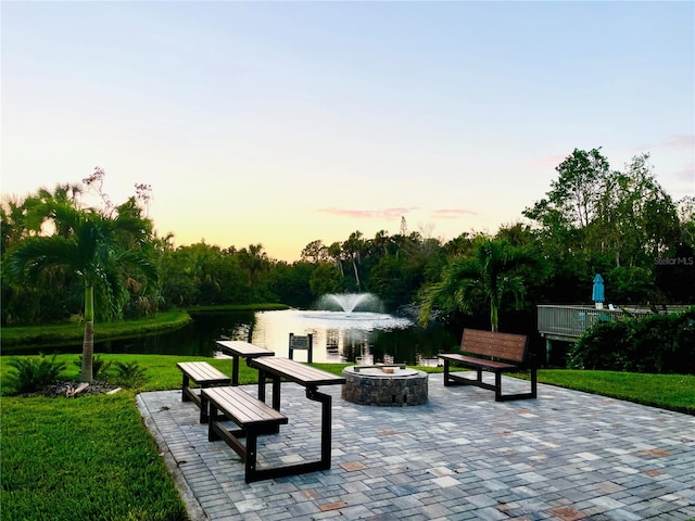 view of community featuring a water view and a yard