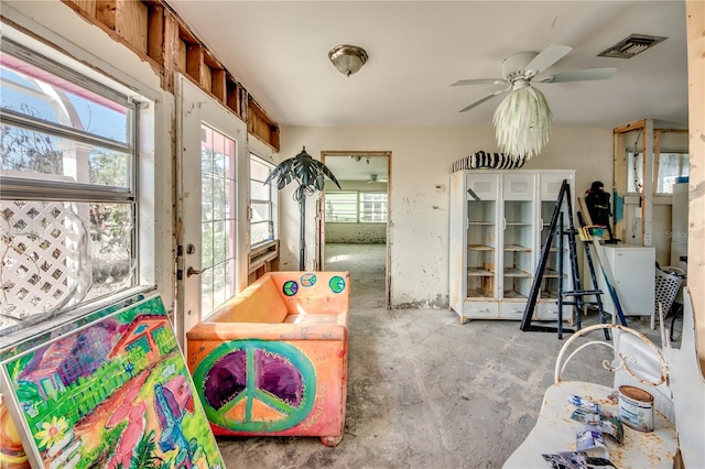 recreation room with concrete flooring and ceiling fan