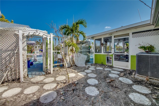 view of patio with a pergola, a sunroom, and cooling unit