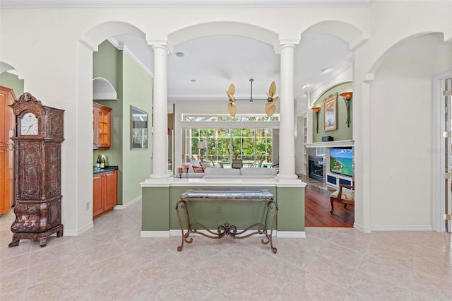 interior space with light tile patterned floors and ornamental molding