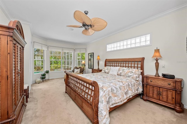 carpeted bedroom featuring ceiling fan and crown molding