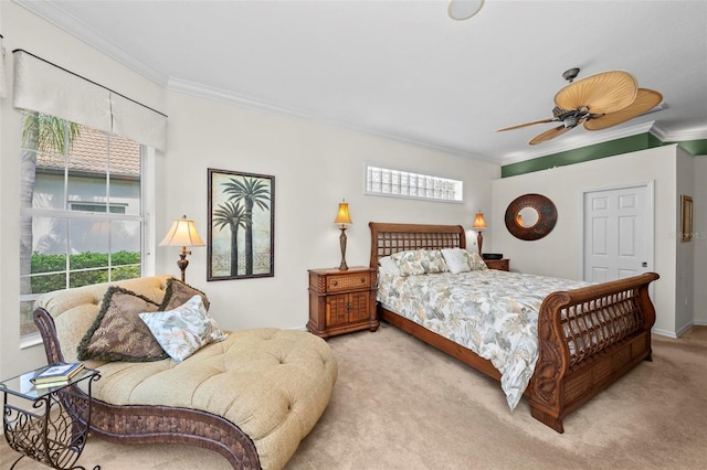 carpeted bedroom with ceiling fan and ornamental molding