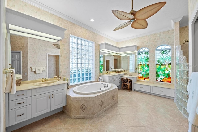 bathroom with ceiling fan, tile patterned flooring, tiled bath, vanity, and ornamental molding