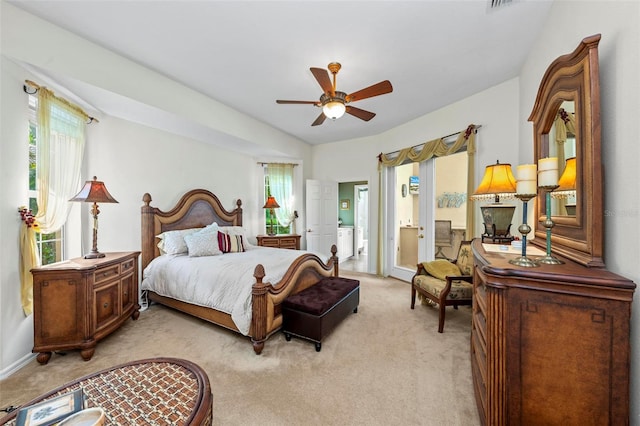 carpeted bedroom with ceiling fan, lofted ceiling, and ensuite bath