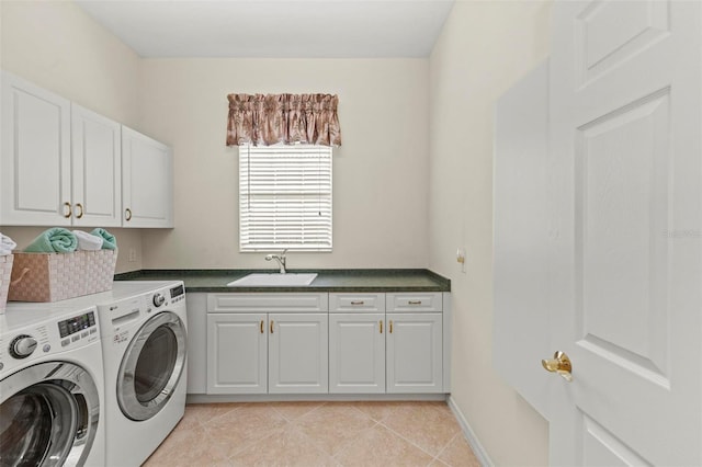 laundry room with cabinets, sink, light tile patterned floors, and washer and dryer