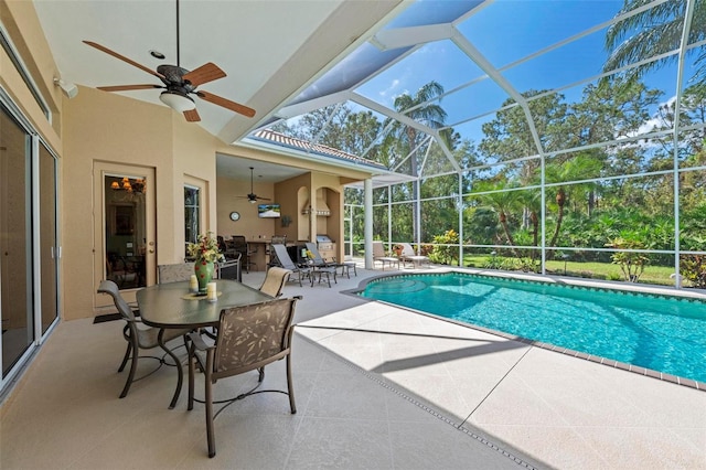 view of pool with a lanai, ceiling fan, and a patio area